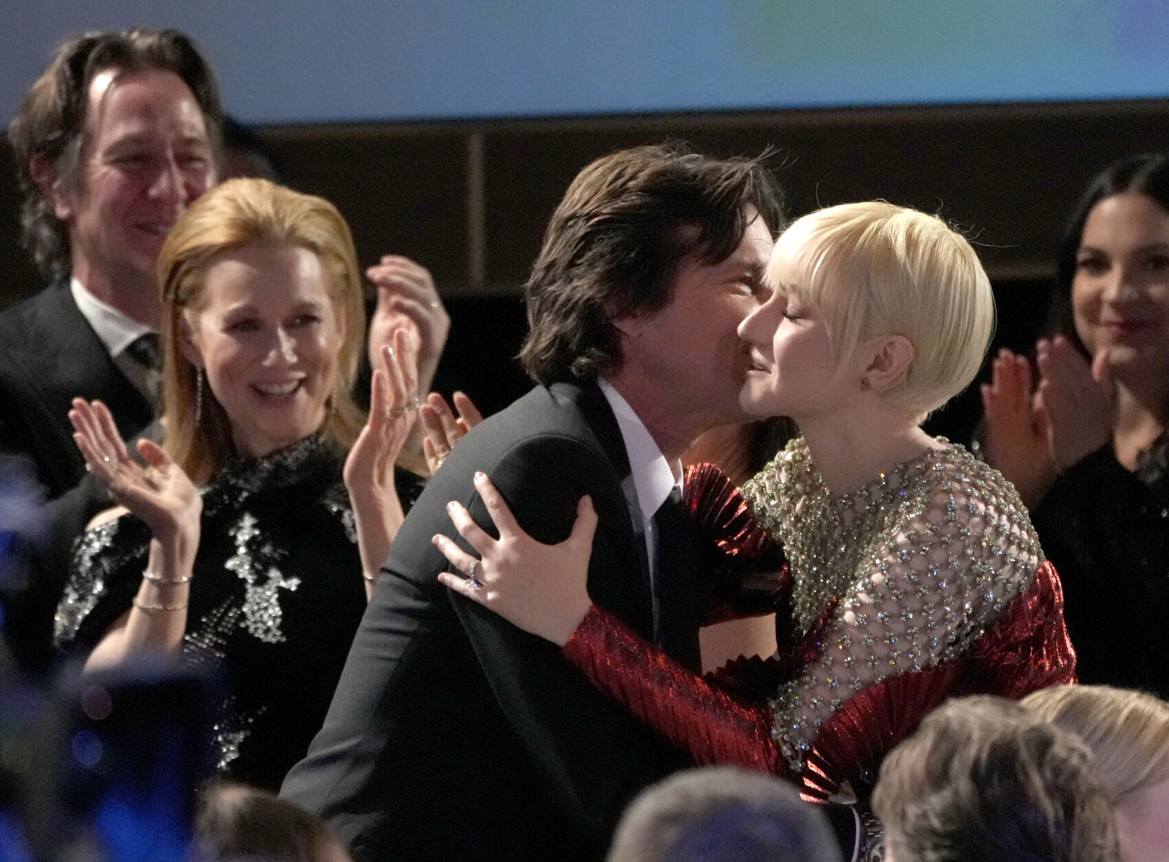 Julia Garner, right, hugs Jason Bateman in the audience as he accepts the award for outstanding performance by a male actor in a drama series for "Ozark" at the 29th annual Screen Actors Guild Awards on Sunday, Feb. 26, 2023, at the Fairmont Century Plaza in Los Angeles. (AP Photo/Chris Pizzello)