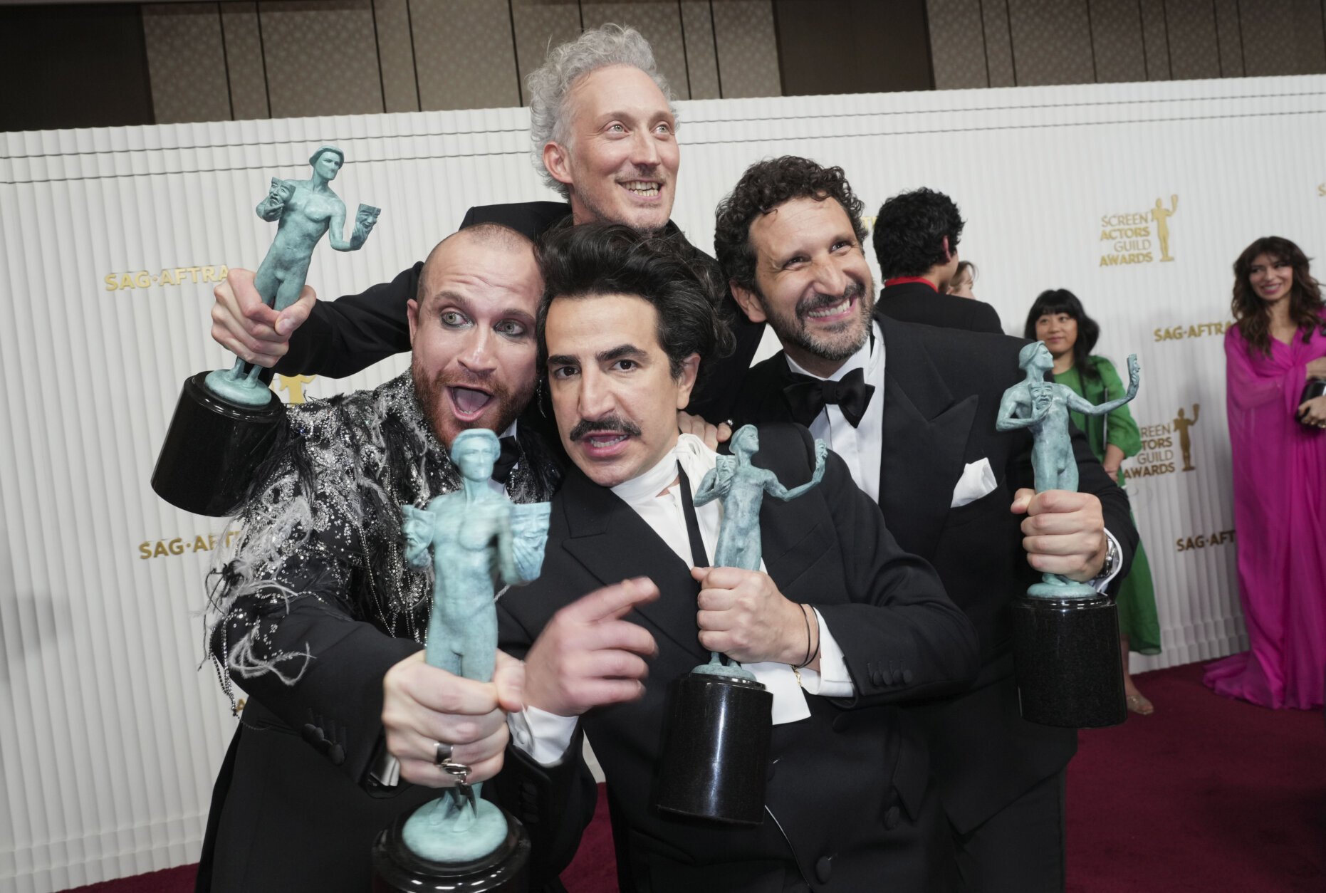 Bruno Gouery, back left, Federico Ferrante, Paolo Camilli, bottom left, and Francesco Zecca from the cast of "The White Lotus," winners of the award for outstanding performance by an ensemble in a drama series, pose in the press room at the 29th annual Screen Actors Guild Awards on Sunday, Feb. 26, 2023, at the Fairmont Century Plaza in Los Angeles. (Photo by Jordan Strauss/Invision/AP)