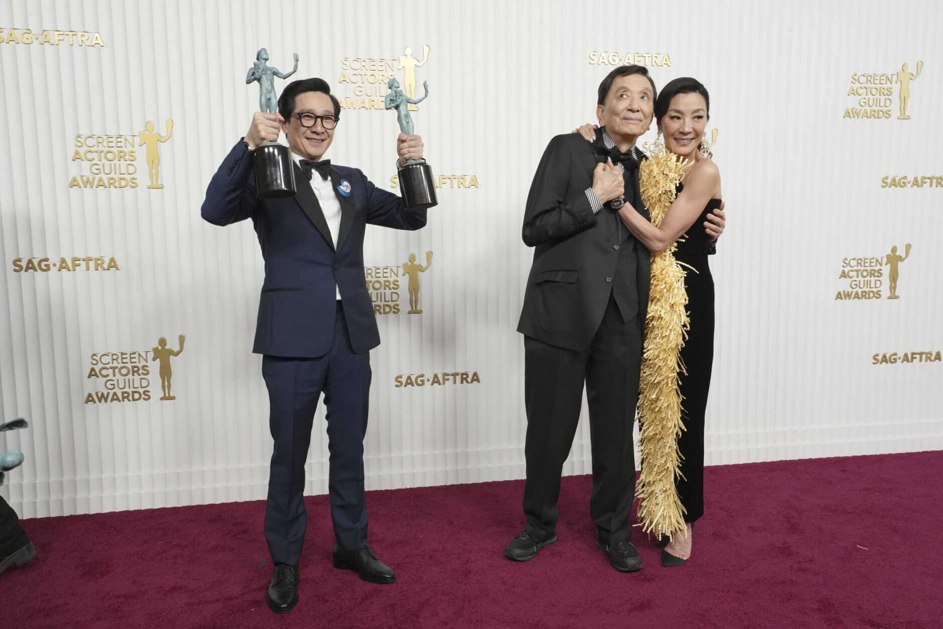 Ke Huy Quan, left, winner of the awards for outstanding performance by a male actor in a supporting role and outstanding performance by a cast in a motion picture for "Everything Everywhere All at Once," poses in the press room at the 29th annual Screen Actors Guild Awards on Sunday, Feb. 26, 2023, at the Fairmont Century Plaza in Los Angeles. Michelle Yeoh, right and James Hong embrace as they pose in the pressroom. (Photo by Jordan Strauss/Invision/AP)