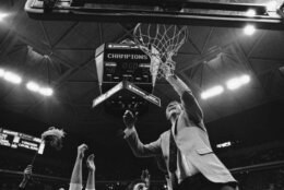 University of Virginia coach Terry Holland cuts the net from the goal with the scoreboard showing his team defeating Indiana University 50-48 in the NCAA East Regional Basketball Finals, Saturday, March 24, 1984, Atlanta, Ga. (AP Photo)