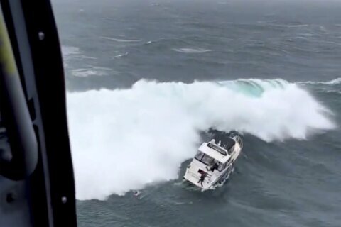 Coast Guard makes dramatic rescue as wave rolls yacht