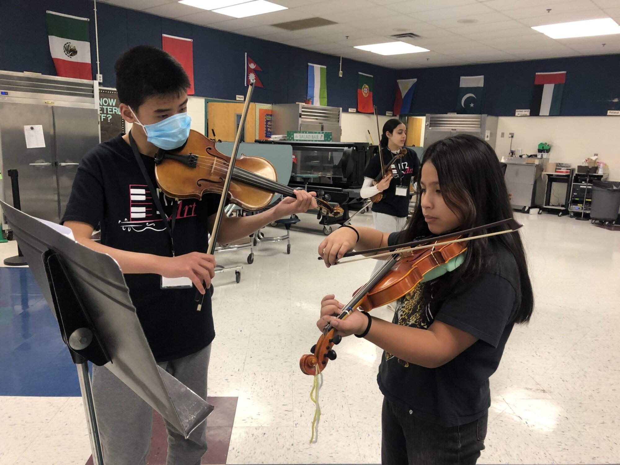 Portrait of school girl (8-9) playing trumpet during music class