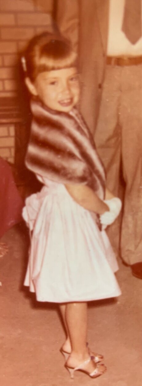 One of the photos shows Cathy Norgaard as a child, already a devotee of formal fashion.