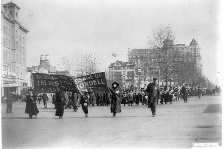 In this photo provided by the Library of Congress, taken in 1913, four women march ahead of large procession with the banner "We demand the passage of the Bristow-Mondell amendment" at the woman suffrage parade in Washington. (Library of Congress via AP)
