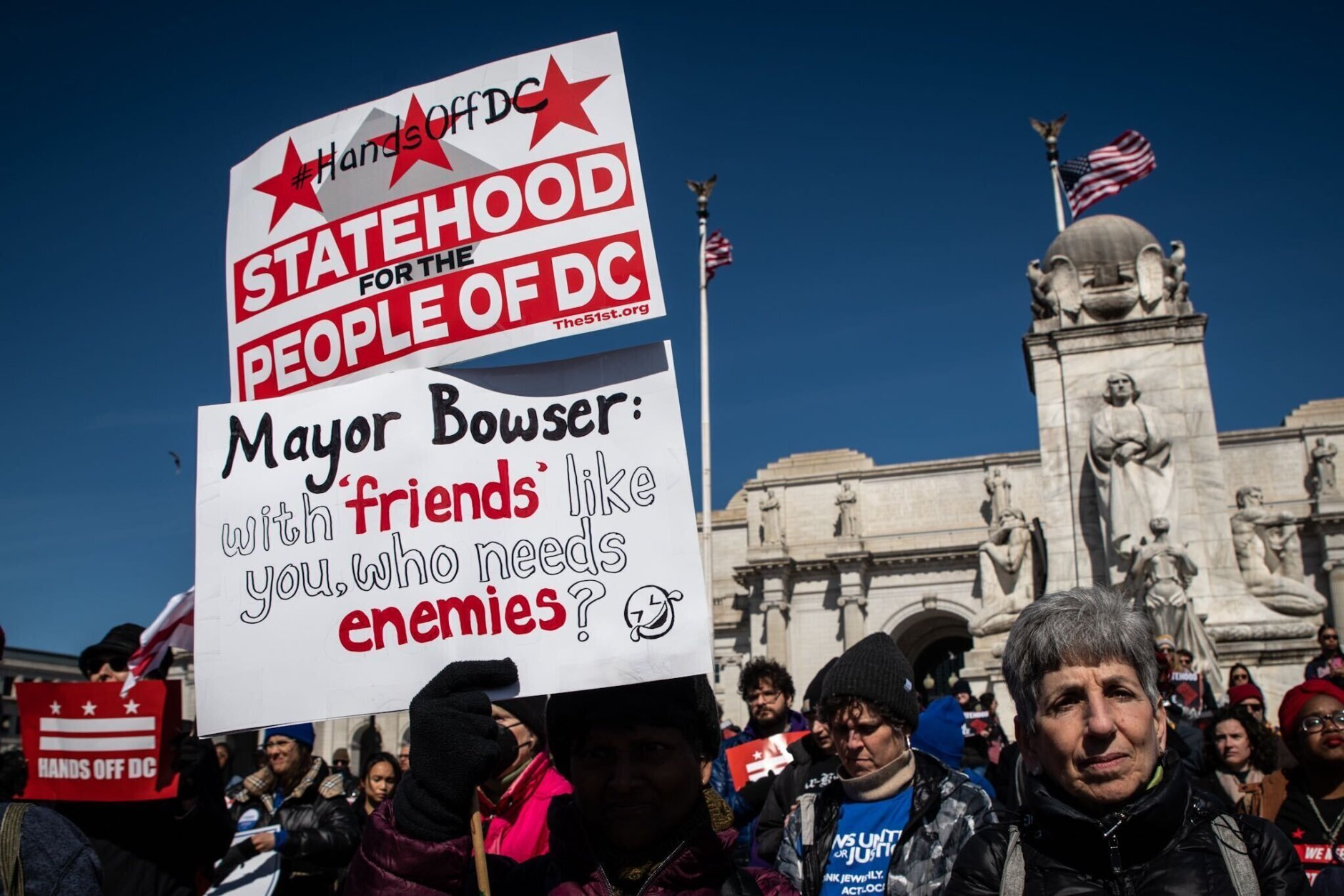 A protester criticizes Mayor Muriel Bowser for vetoing an overhaul of the city's aging criminal code, ahead of a Senate vote to overturn the bill on March 8, 2023. (WTOP/Alejandro Alvarez)