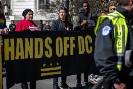 Protesters supporting D.C. statehood risk arrest by blocking traffic at the intersection of Constitution Avenue and First Street on March 8, 2023. (WTOP/Alejandro Alvarez)