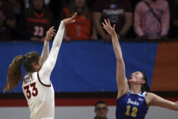 CORRECTS TO SECOND-ROUND NOT FIRST-ROUND - Virginia Tech's Elizabeth Kitley (33) shoots over South Dakota State's Kallie Theisen (12) in the first quarter of a second-round college basketball game in the women's NCAA Tournament, Sunday, March 19, 2023, in Blacksburg, Va. (AP Photo/Matt Gentry)