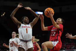 Arizona guard Paris Clark (22) goes up for a shot against Maryland guard Diamond Miller (1) during the first half of a second-round college basketball game in the NCAA Tournament, Sunday, March 19, 2023, in College Park, Md. (AP Photo/Julio Cortez)