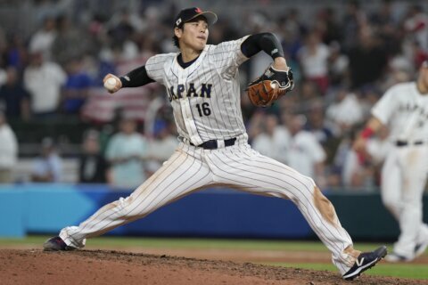 Ohtani returns to Angels camp, fans 8 in minor league game