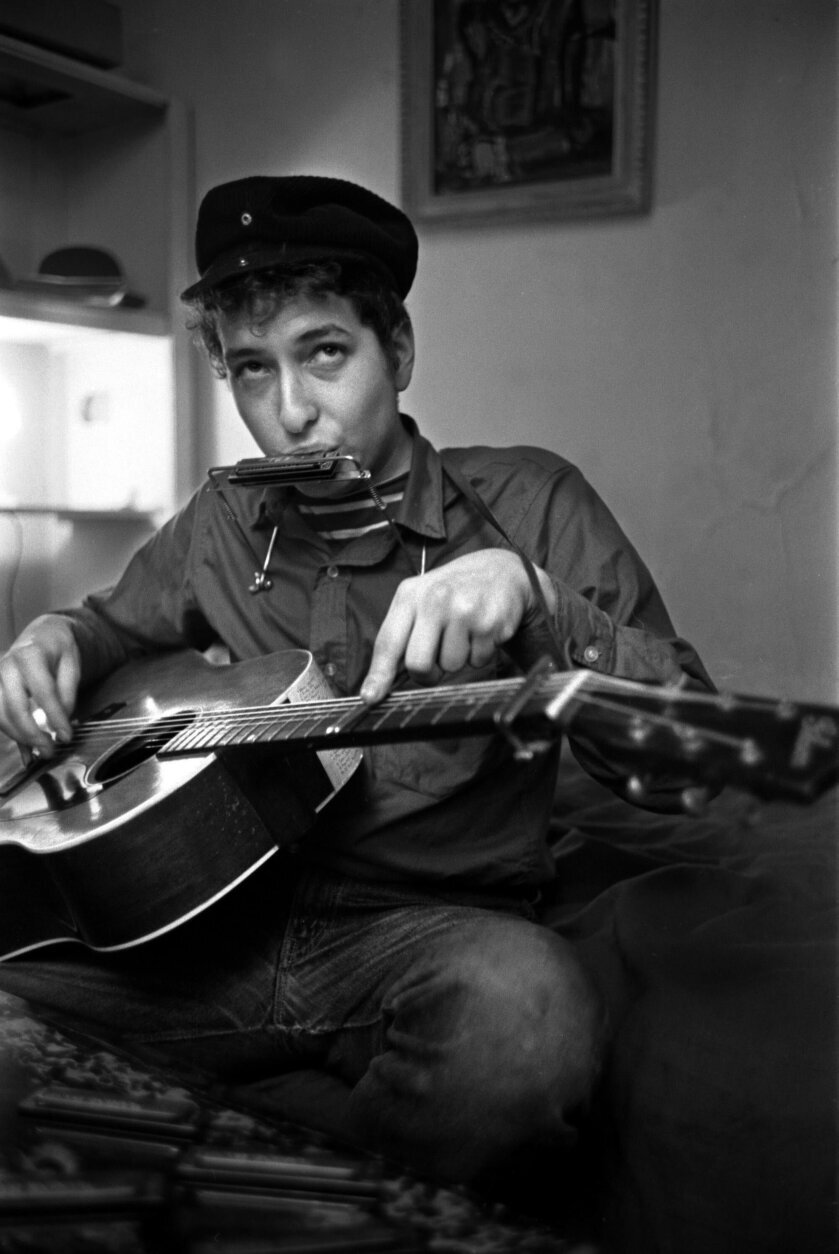 <p>When Russell photographed Dylan in November 1961, at Gerde&#8217;s Folk City, &#8220;Dylan&#8217;s first album had been recorded, but not yet released,&#8221; said Murray. &#8220;Bob was, no pun intended, a complete unknown,&#8221; referencing a lyric from &#8220;Like a Rolling Stone&#8221; that Dylan wouldn&#8217;t write until 1965.</p>
<p>At the time, Dylan was mostly performing folk classics written by other artists. His first album, titled &#8220;Bob Dylan,&#8221; contained only two songs written by the Minnesota-born Robert Zimmerman.</p>
