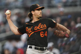 Baltimore Orioles starting pitcher Dean Kremer (64) delivers in the first inning of a baseball game against the Atlanta Braves, Friday, May 5, 2023, in Atlanta. (AP Photo/John Bazemore)