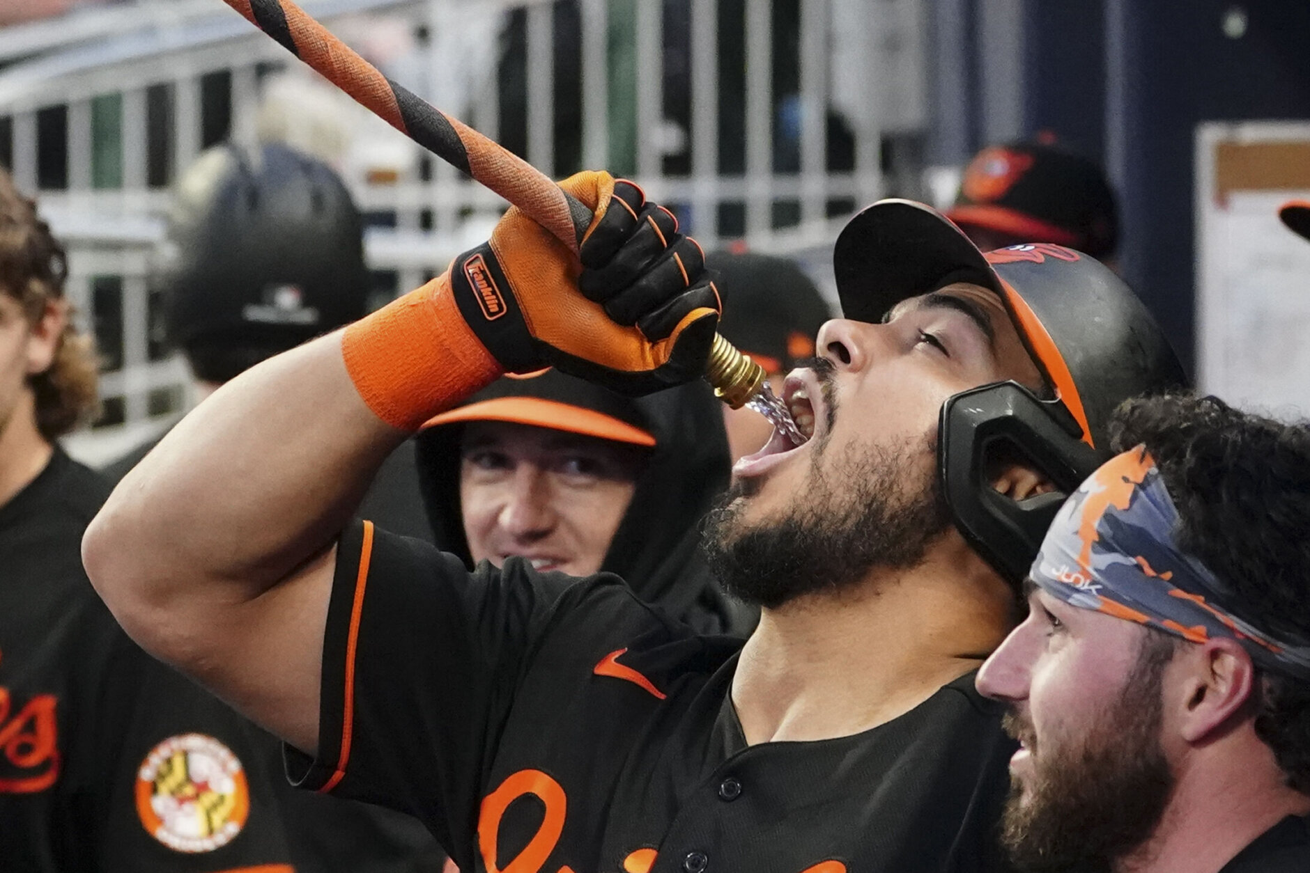 Baltimore Orioles right fielder Anthony Santander (25) drinks from a hose as he celebrates a home run in the fourth inning of a baseball game against the Atlanta Braves Friday, May 5, 2023, in Atlanta. (AP Photo/John Bazemore)
