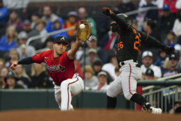 Baltimore Orioles' Ryan McKenna (26) is safe at first base with a single as Atlanta Braves first baseman Matt Olson (28) handles the late throw in the third inning of a baseball game Friday, May 5, 2023, in Atlanta. (AP Photo/John Bazemore)