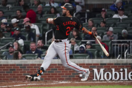 Baltimore Orioles' Anthony Santander (25) follows through on a grand slam in the seventh inning of a baseball game against the Atlanta Braves, Friday, May 5, 2023, in Atlanta. The home run was his second of the game. (AP Photo/John Bazemore)