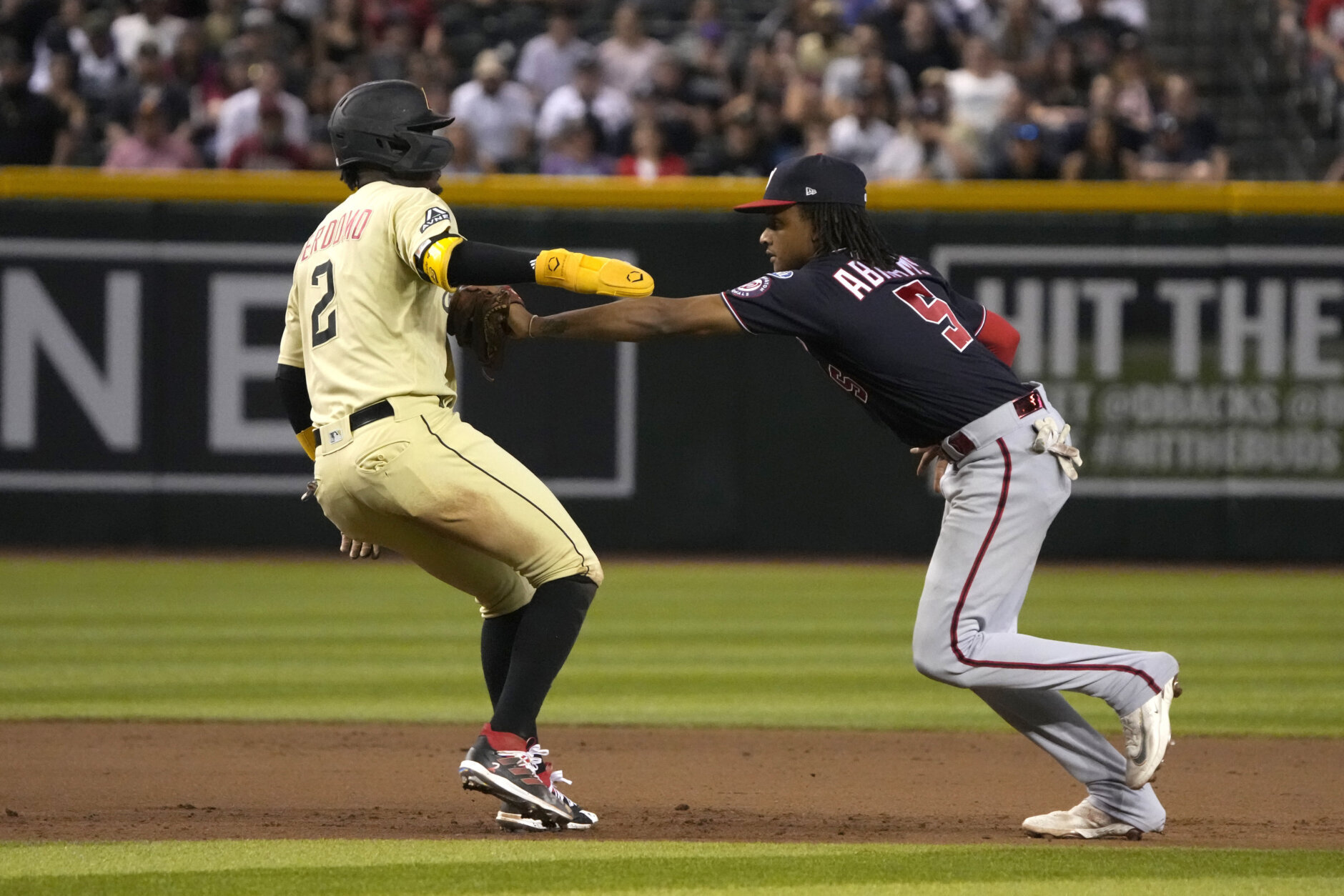 Arizona Diamondbacks' Geraldo Perdomo (2) is tagged out trying to steal secondbase by Washington Nationals shortstop CJ Abrams, right, in the fourth inning during a baseball game, Friday, May 5, 2023, in Phoenix. (AP Photo/Rick Scuteri)