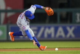 New York Mets shortstop Francisco Lindor fields a ball bare-handed before throwing to first base for the out on Washington Nationals' Keibert Ruiz during the eighth inning of a baseball game at Nationals Park, Friday, May 12, 2023, in Washington. The Mets won 3-2. (AP Photo/Alex Brandon)