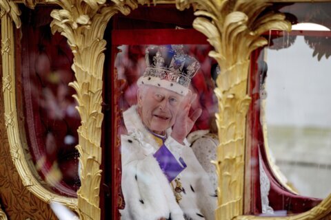 King Charles III crowned with regal pomp, cheers and shrugs