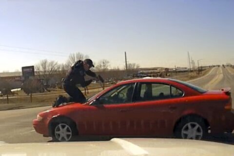 Video shows driver fleeing Iowa police with officer on hood, roof of car