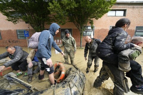 Crews work to reach Italian towns isolated by floods as toll rises to 13 and cleanup begins