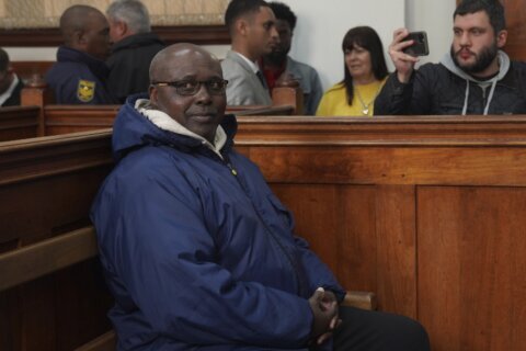 Rwandan genocide suspect appears in court holding Bible after 22 years on the run