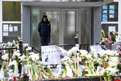 Thousands march in silence in Serbia after mass shootings