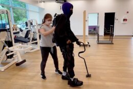 Khalil Watson practices walking in an exoskeleton years after he was paralyzed in a shooting.