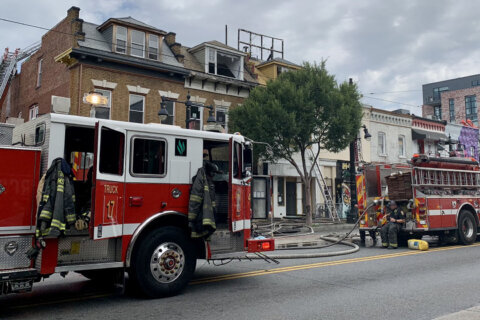 H Street roof deck fire hospitalizes firefighter