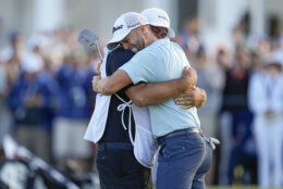 Wyndham Clark celebrates with his caddie on the 18th hole after winning the U.S. Open golf tournament at Los Angeles Country Club on Sunday, June 18, 2023, in Los Angeles. (AP Photo/George Walker IV)