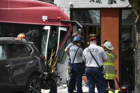 16 injured as Baltimore bus crashes into 2 cars, apartment building
