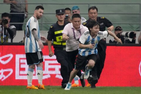 Lionel Messi scores, gets hugged by a fan during Argentina’s 2-0 win over Australia