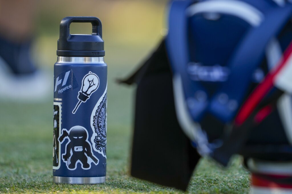 Stickers adorn Rickie Fowler’s ever-present water bottle at US Open