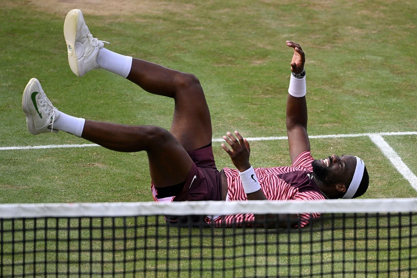 Tiafoe fell to the floor in celebration after winning match point.