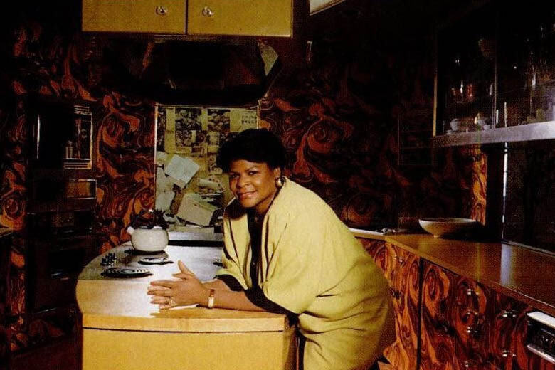 Food editor Charlotte Lyons in the test kitchen, published in the November 1992 issue of Ebony magazine. Photograted by Vandell Cobb.(Courtesy J. Paul Getty Trust and Smithsonian National Museum of African American History and Culture).