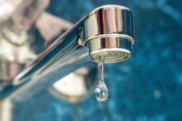 Stock photo of water dripping from a sink faucet