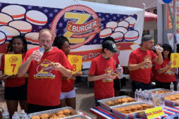 Contestants took sips of water between burgers at the 14th Annual Independence Burger Eating Competition outside of the Tenleytown Z-Burger