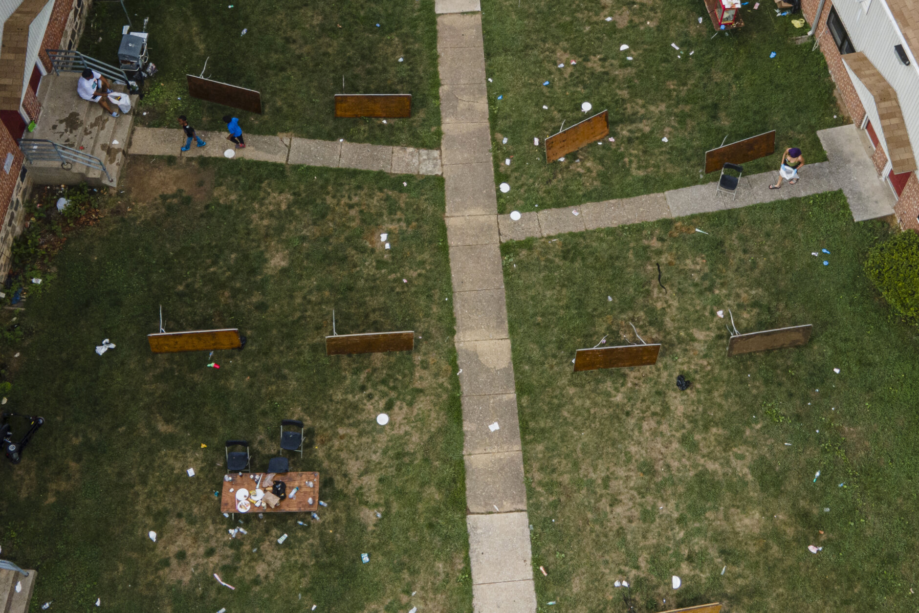 Tables are left on their side in the area of a mass shooting incident in the Southern District of Baltimore, Sunday, July 2, 2023. Police say a number of people were killed and dozens were wounded in a mass shooting that took place during a block party just after midnight. (AP Photo/Julio Cortez)