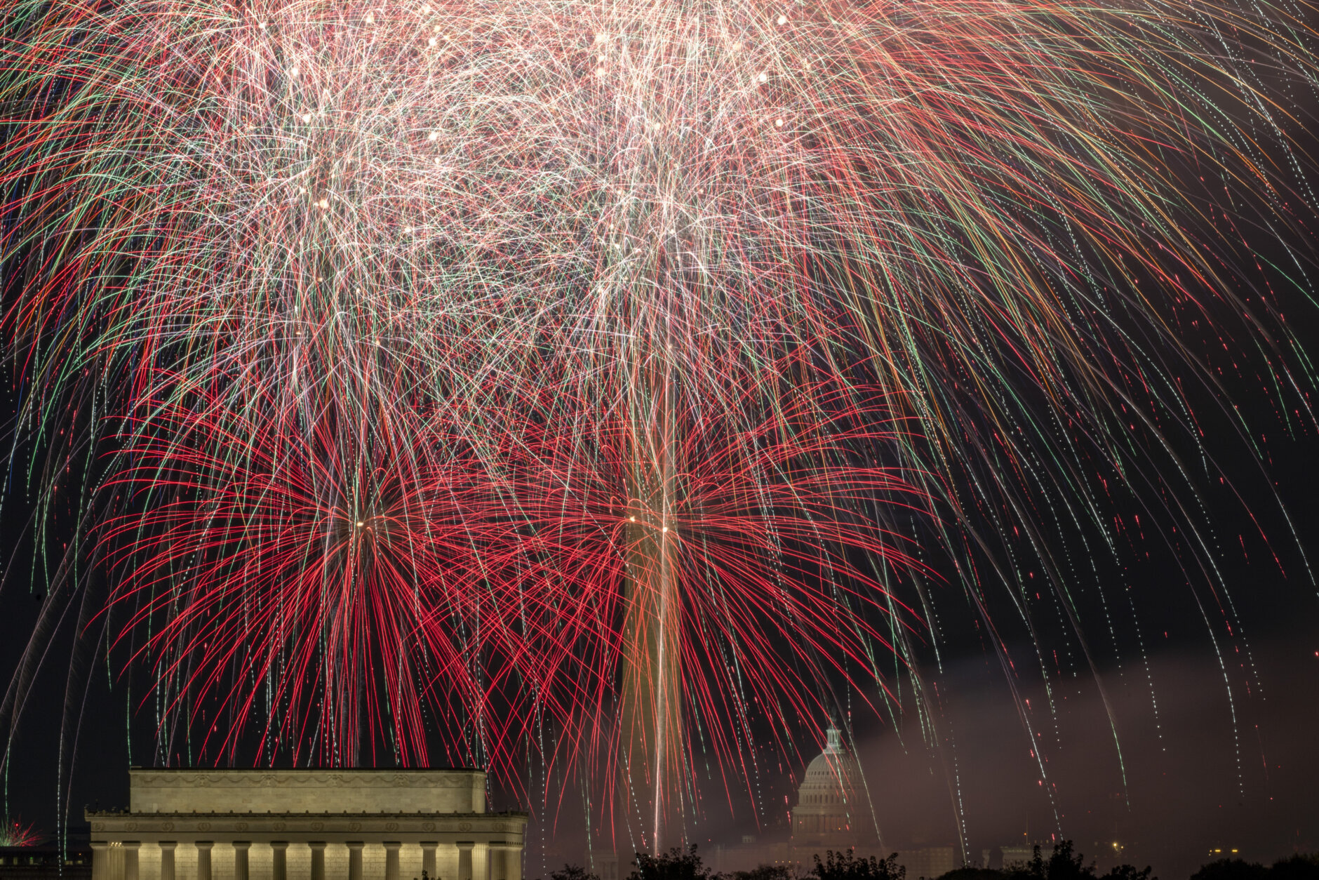 Fireworks burst on the National Mall above the Lincoln Memorial, Washington Monument and the U.S. Capitol building during Independence Day celebrations in Washington, late Tuesday, July 4, 2023. (AP Photo/Stephanie Scarbrough)