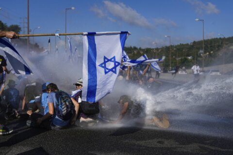 Israelis block highways and throng airport in protest at government's plan to overhaul the judiciary