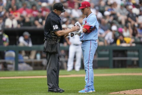 Cardinals reliever Gallegos gets wiped down by umpire after using rosin bag on his left arm