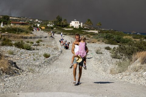 Fire still blazing on the Greek island of Rhodes as dozens more erupt across the country