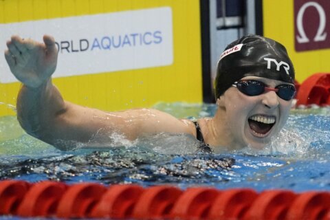 Katie Ledecky wins gold in 1,500 at the swimming worlds to tie mark set by Michael Phelps