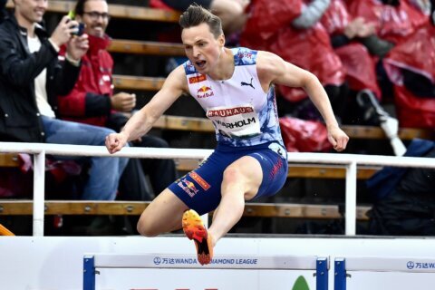 An Olympic champion boos protesters who knelt on the track near the finish line of his race