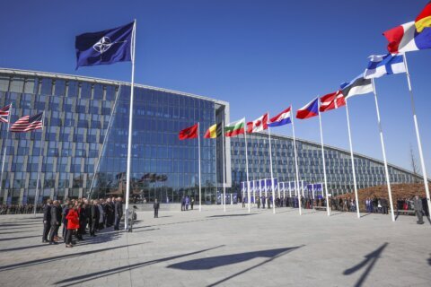 NATO foreign ministers pose during a ceremony to raise the Finnish flag
