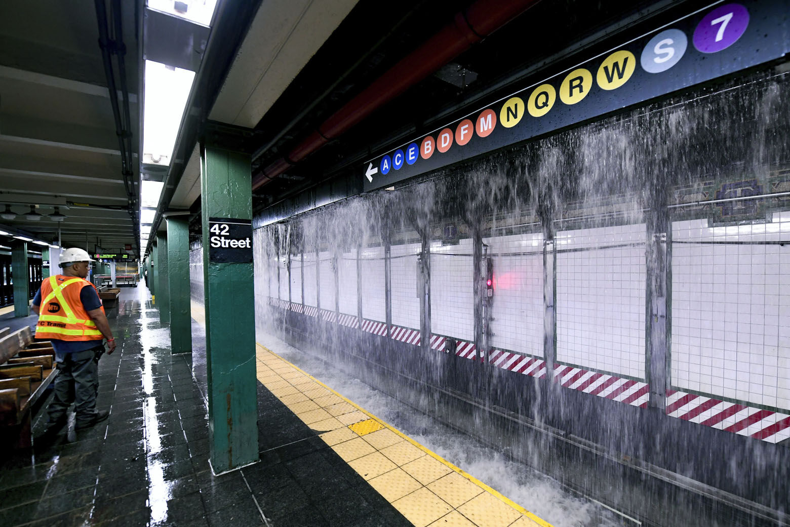 This photo, provided by MTA New York City Transit, shows water from a water main break cascading into New York's Times Square subway station, Tuesday, Aug. 29, 2023. A 127-year-old, 20-inch water main under New York's Times Square gave way early Tuesday, flooding midtown streets and the city's busiest subway station. (Marc A. Hermann/MTA, via AP)