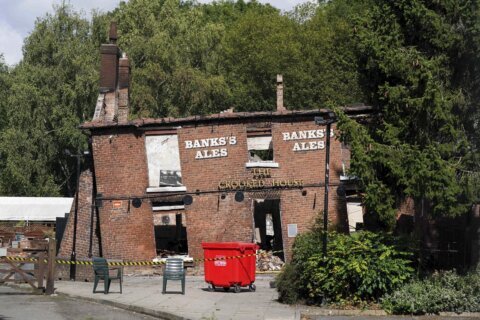 Police arrest two men in suspected torching of British pub cherished for its lopsided walls
