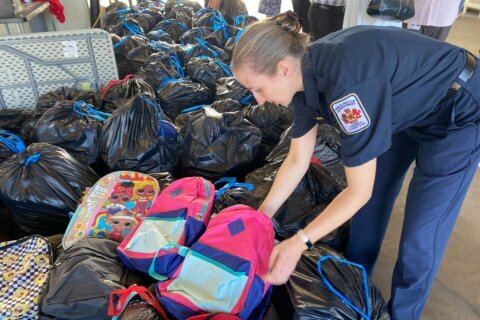 Fairfax Co. firefighters help kids get ready to go back to school with new backpacks, supplies