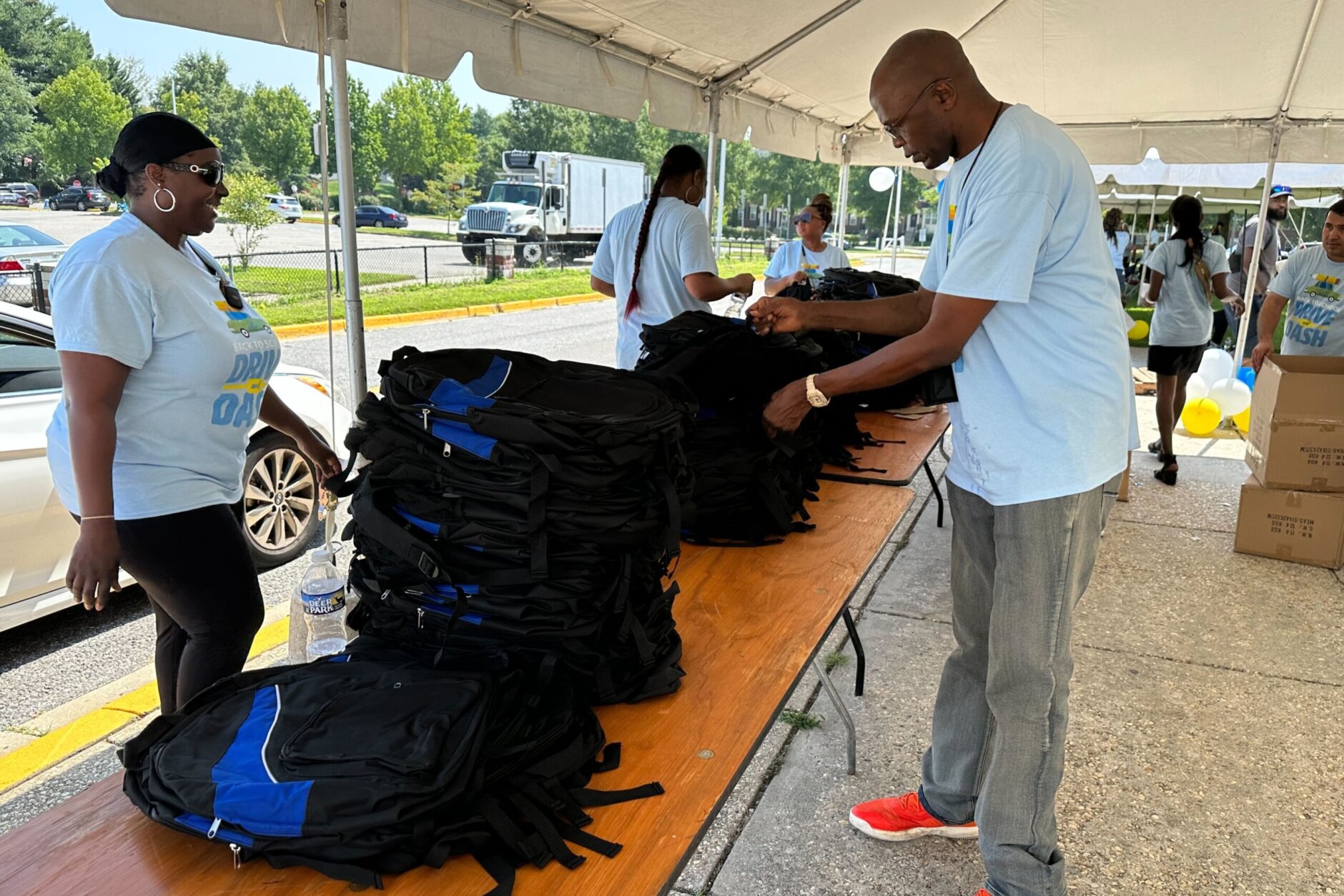 Volunteers organizing backpacks at the Back-To-School Drive and Dash donation event (WTOP/Matt Kaufax)