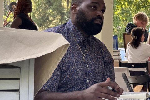 Michael Oher greets fans at a Baltimore book signing a week after suing to end his conservatorship