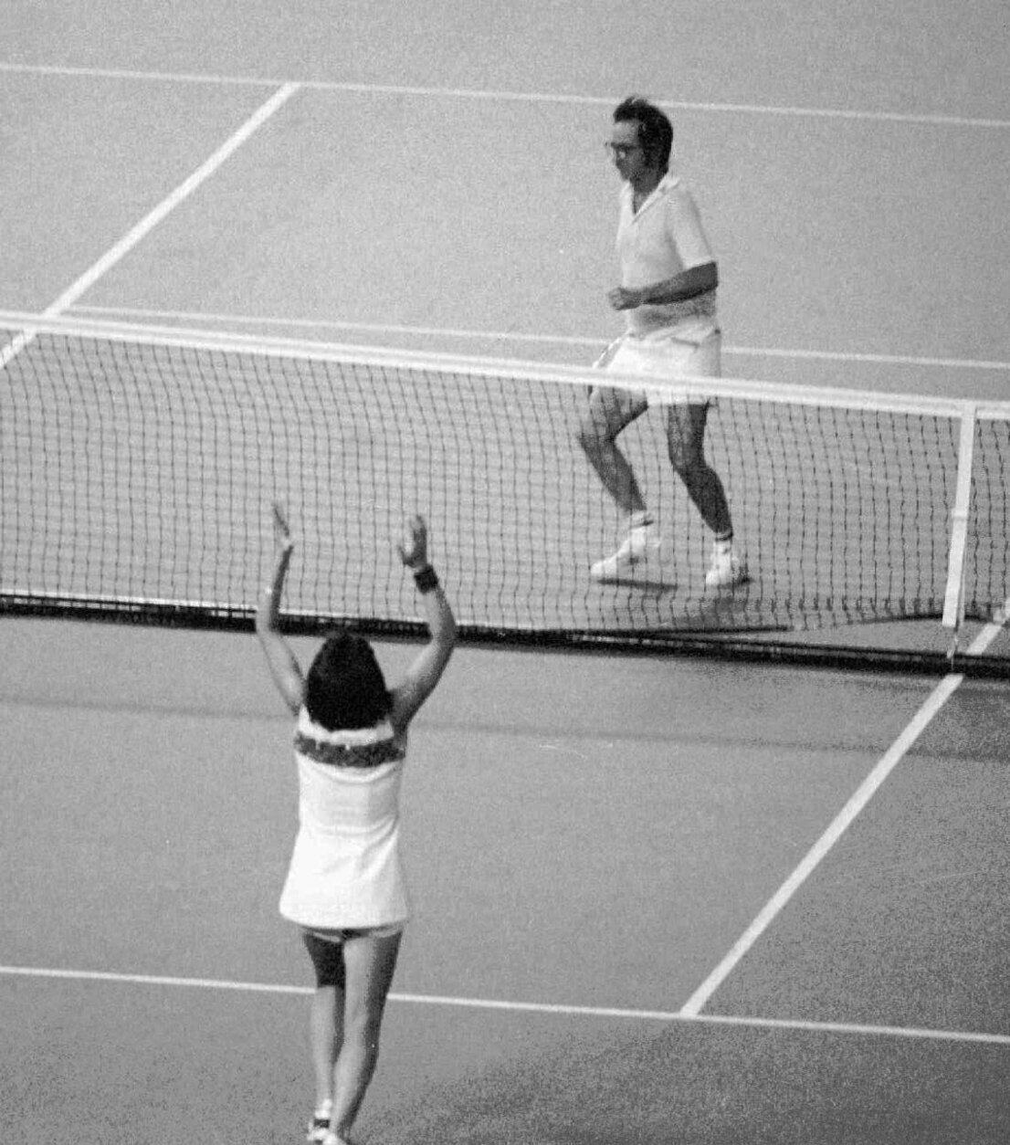FILE - In this Sept. 20, 1973, file photo, Billie Jean King raises her arms after defeating Bobby Riggs, rear, getting ready to jump over the net, in the "Battle of the Sexes" tennis match at the Houston Astrodome. The story of the early days of the tour and King's fight for equal prize money is chronicled in the movie "Battle of the Sexes," which opened nationwide on Friday.  (AP Photo, File)