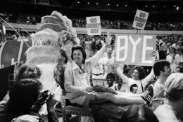 FILE - In this Sept. 20, 1973, file photo, . Billie Jean King waves to crowds at the Astrodome in Houston, Texas, as she is borne onto the crowd on a multi-colored throne carried by four men for her match with Bobby Riggs. The story of the early days of the tour and King's fight for equal prize money is chronicled in the movie "Battle of the Sexes," which opened nationwide on Friday. (AP Photo/File)
